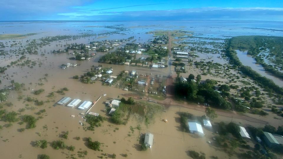 Murky water has transformed wide areas of land into lakes, with only the tops of trees visible, images of the Queensland town show.