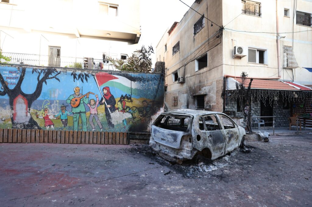 A burnt-out car in a courtyard after the Israeli army raid in Jenin, West Bank, July 5, 2023. (EPA Photo)