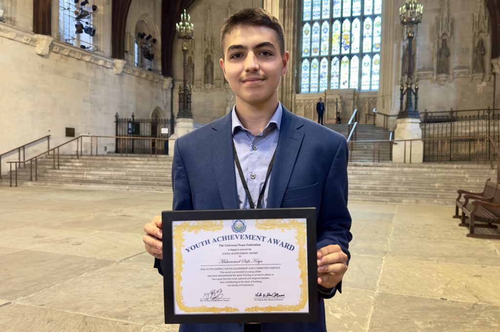 Sixteen-year-old Muhammed Safa Kaya poses with his award presented by the U.N.'s Universal Peace Federation (UPF) for outstanding leadership performance, Watford, U.K., July 12, 2023. (AA Photo)