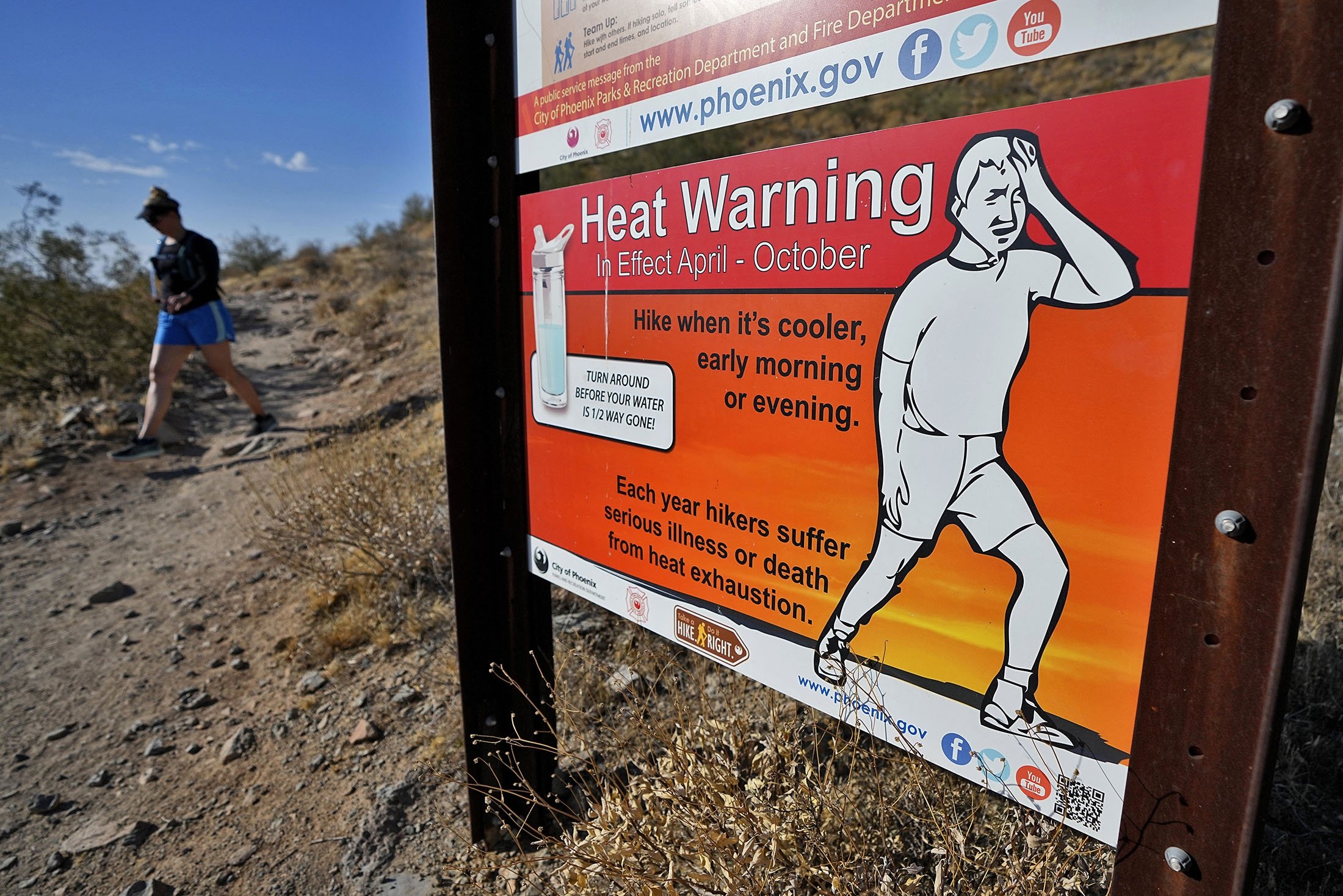 282123 A hiker finishes her hike early to beat high temperatures, in Phoenix, U.S., July 10, 2023. (AP Photo)