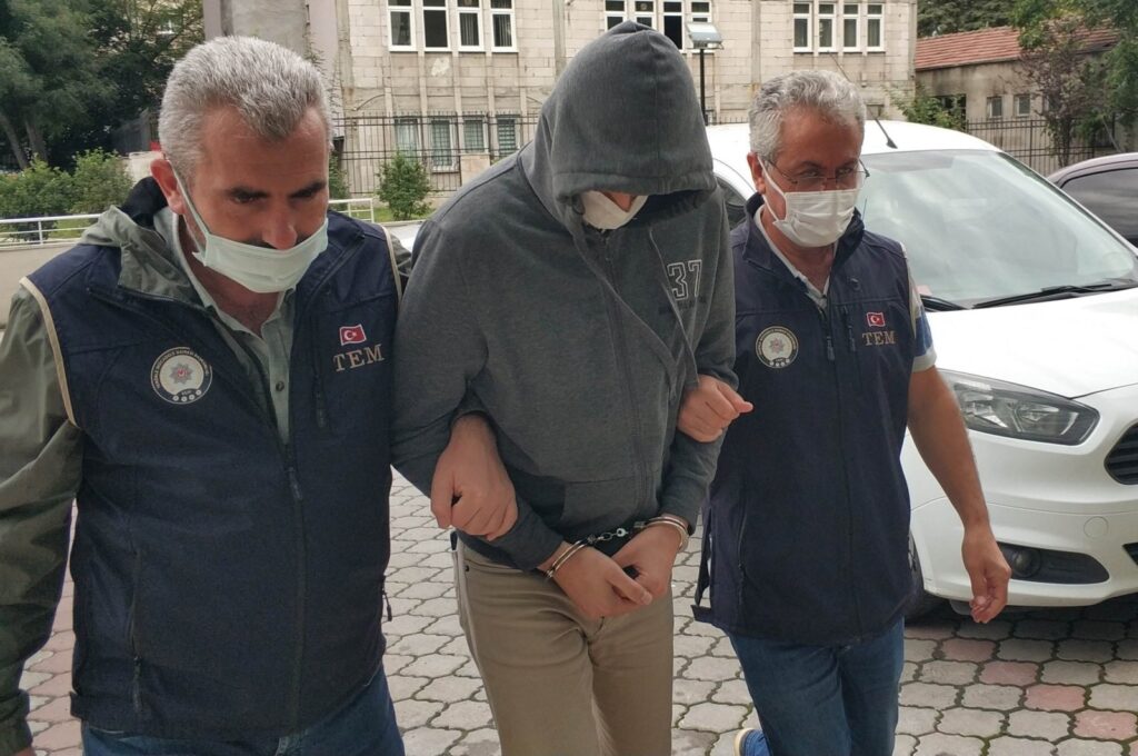 Police escort a FETÖ suspect captured in an operation in Denizli, western Türkiye, March 20, 2023. (İHA Photo)