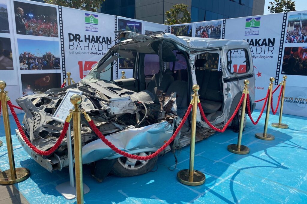 A crushed car displayed at the opening of the "That Moment" photography exhibition at Bahçelievler Municipality, Istanbul, Türkiye, July 12, 2023. (AA Photo)
