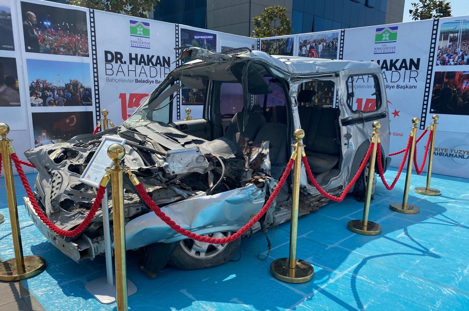 A crushed car displayed at the opening of the "That Moment" photography exhibition at Bahçelievler Municipality, Istanbul, Türkiye, July 12, 2023. (AA Photo)