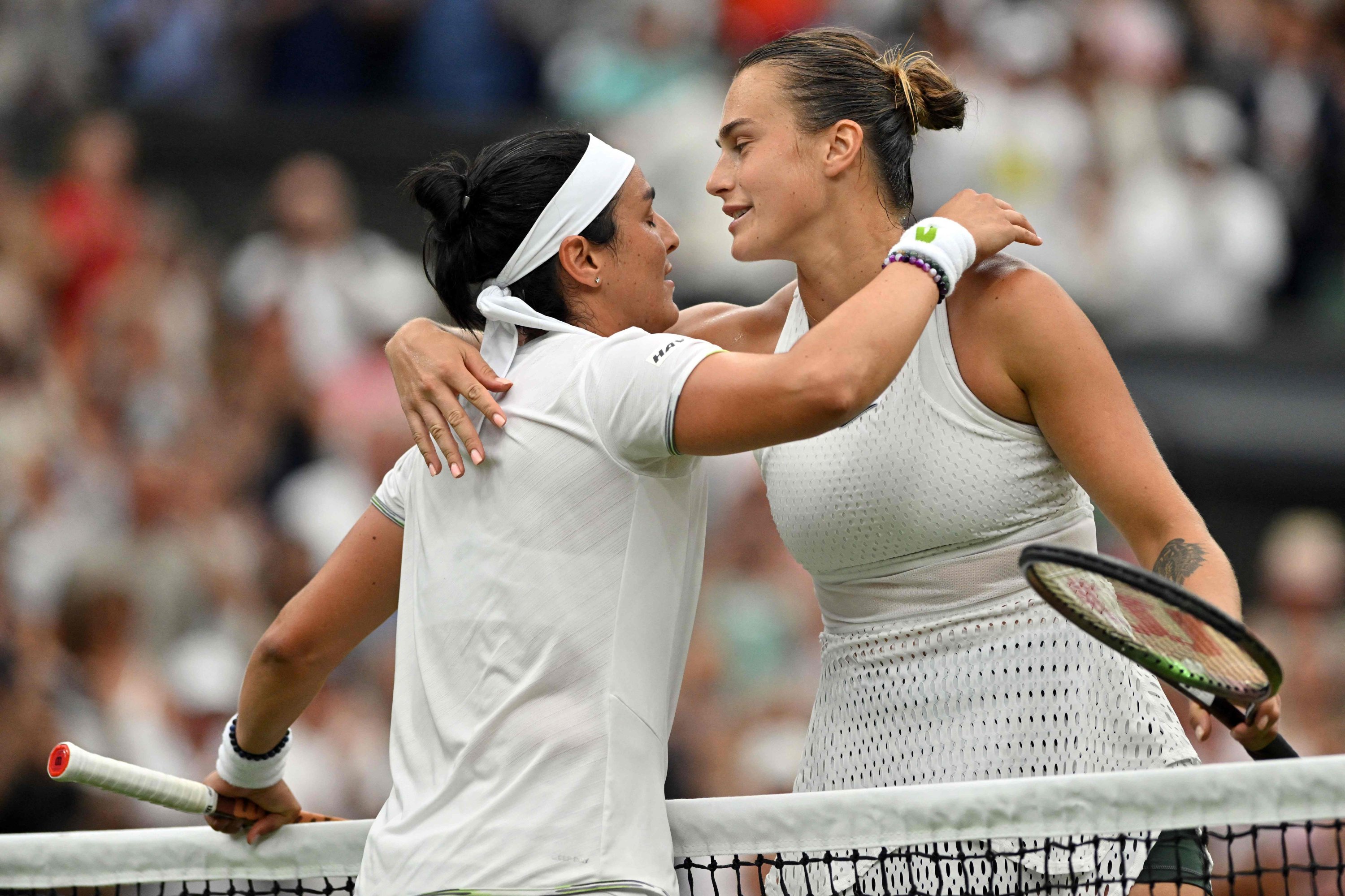 282468 Tunisia's Ons Jabeur (L) hugs Belarus' Aryna Sabalenka after winning their women's singles semifinals tennis match on the 11th day of the 2023 Wimbledon Championships at the All England Lawn Tennis Club in Wimbledon, London, U.K., July 13, 2023. (AFP Photo)