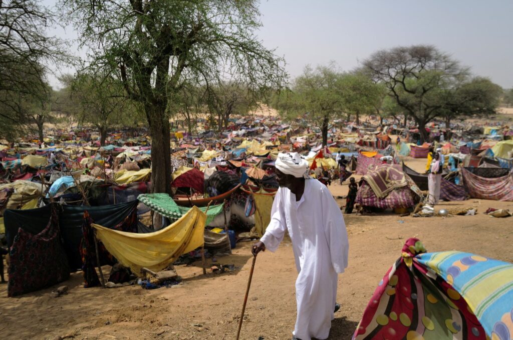 A Sudanese men who fled the conflict in Sudan's Darfur region walks past makeshift shelters near Borota, Chad, May 13, 2023. (Reuters Photo)