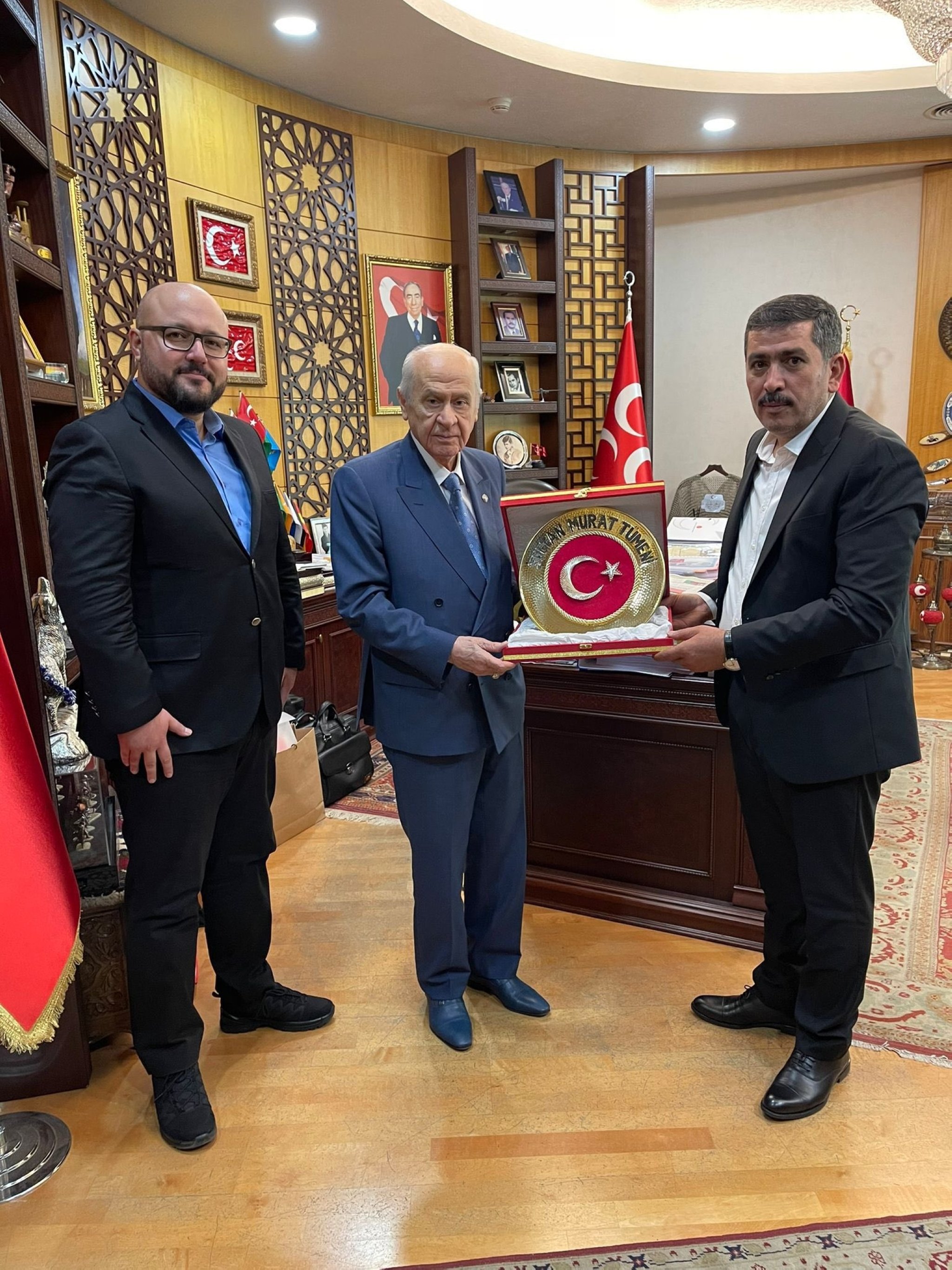 283109 Fehim Ertuğrul Isa presents a gift to Devlet Bahçeli (C), in the capital Ankara, Türkiye, July 18, 2023. (Courtesy of the MHP)