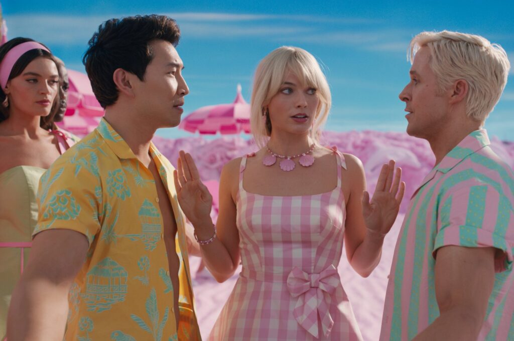 A still shot from "Barbie" shows Barbies and Kens. (Photo courtesy of Warner Bros)