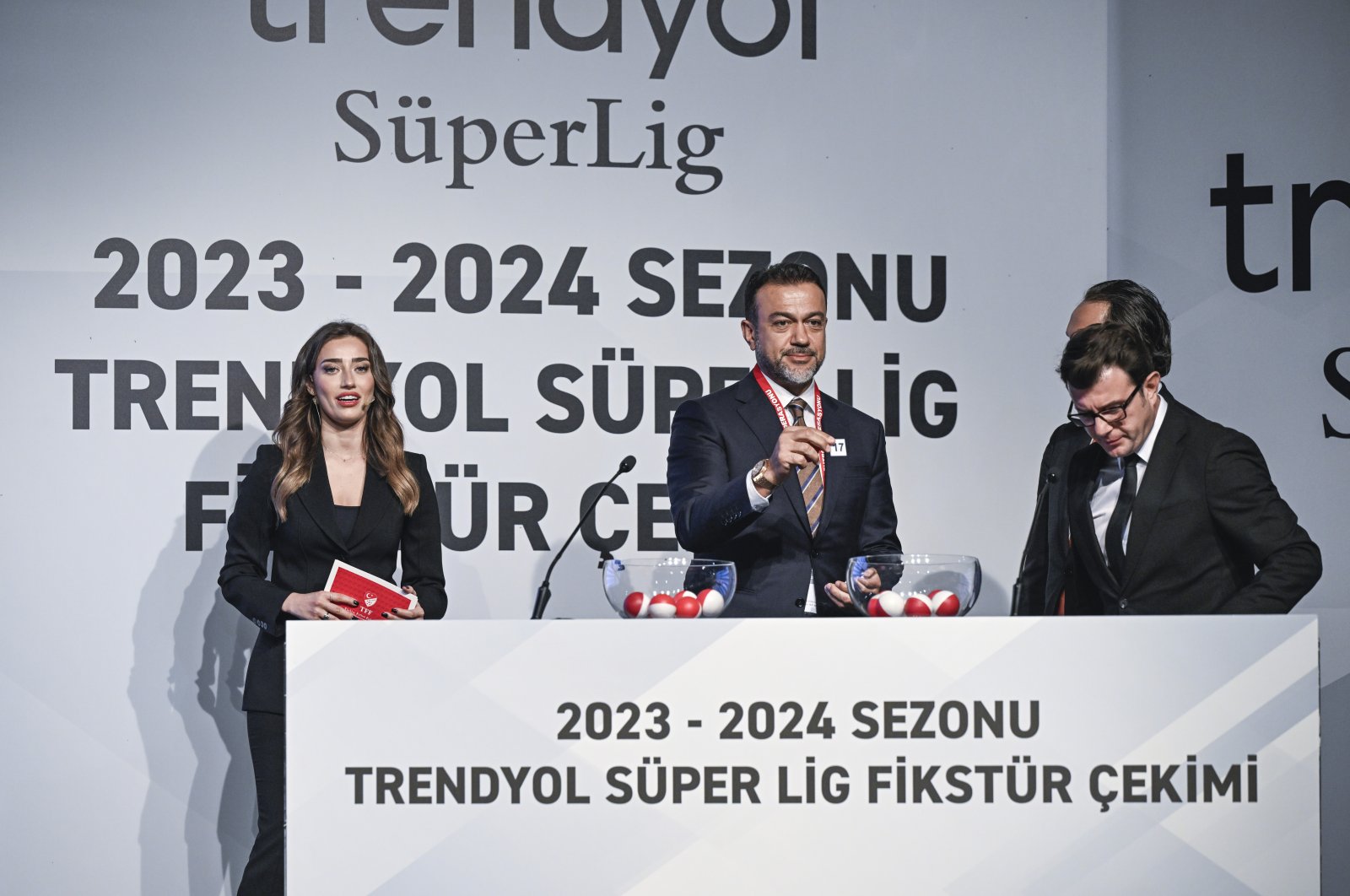 A Turkish Football Federation (TFF) official holds a number during the Turkish Süper Lig fixtures draw, Istanbul, Türkiye, July 18, 2023. (AA Photo)