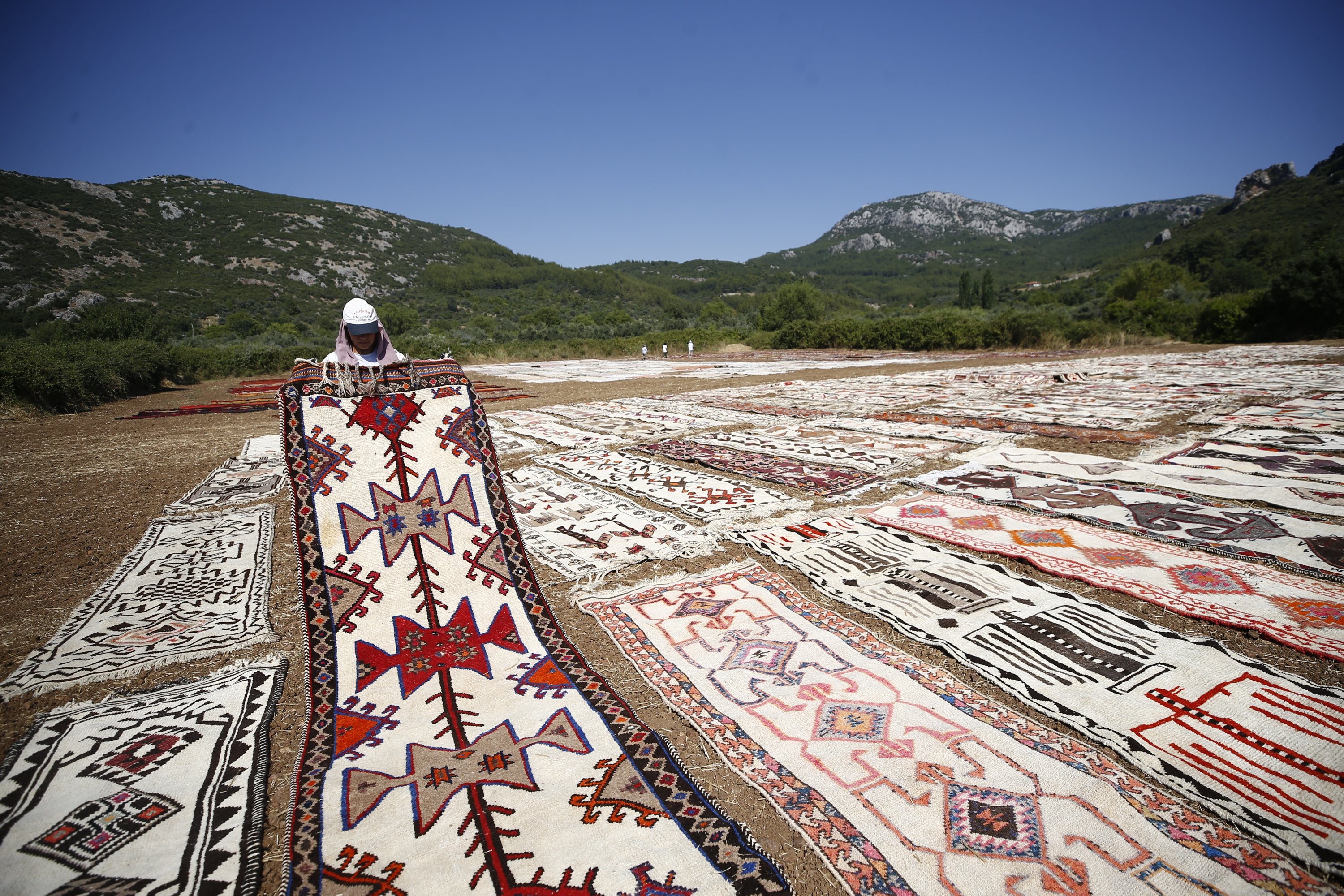 283700 Wheat fields in Antalya's Döşemealtı district turn into a colorful oasis of handwoven carpets, Antalya, southern Türkiye, July 20, 2023. (AA Photo)