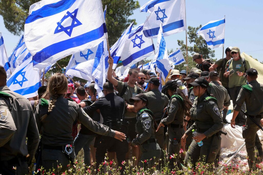 Protesters wave the Israeli flag during a demonstration near the Knesset in Jerusalem, July 24, 2023. (AFP Photo)