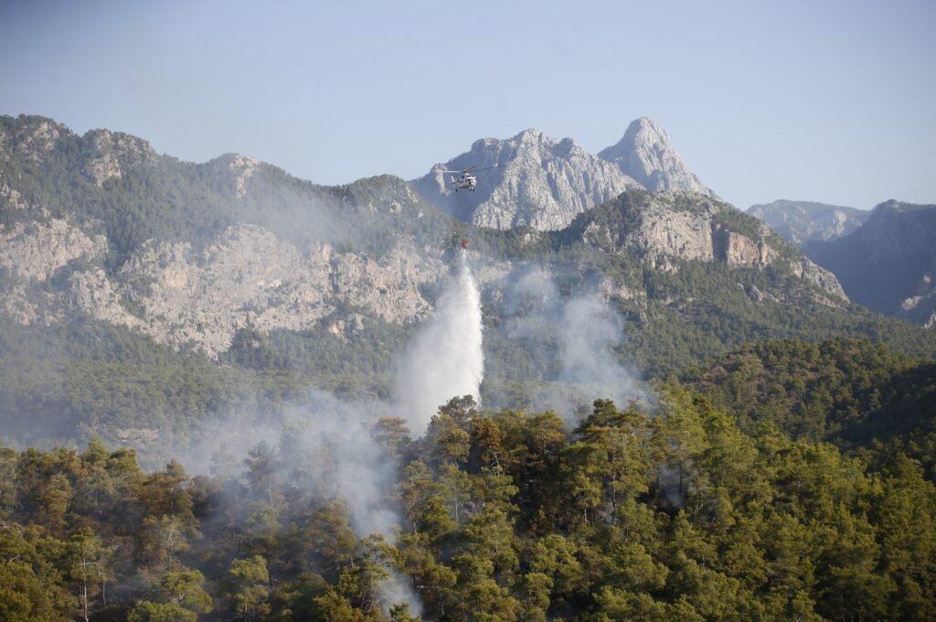 A view of the helicopter extinguishing the fire that engulfed forests in Kemer district of Antalya, southern Türkiye, July 25, 2023. (AA Photo)
