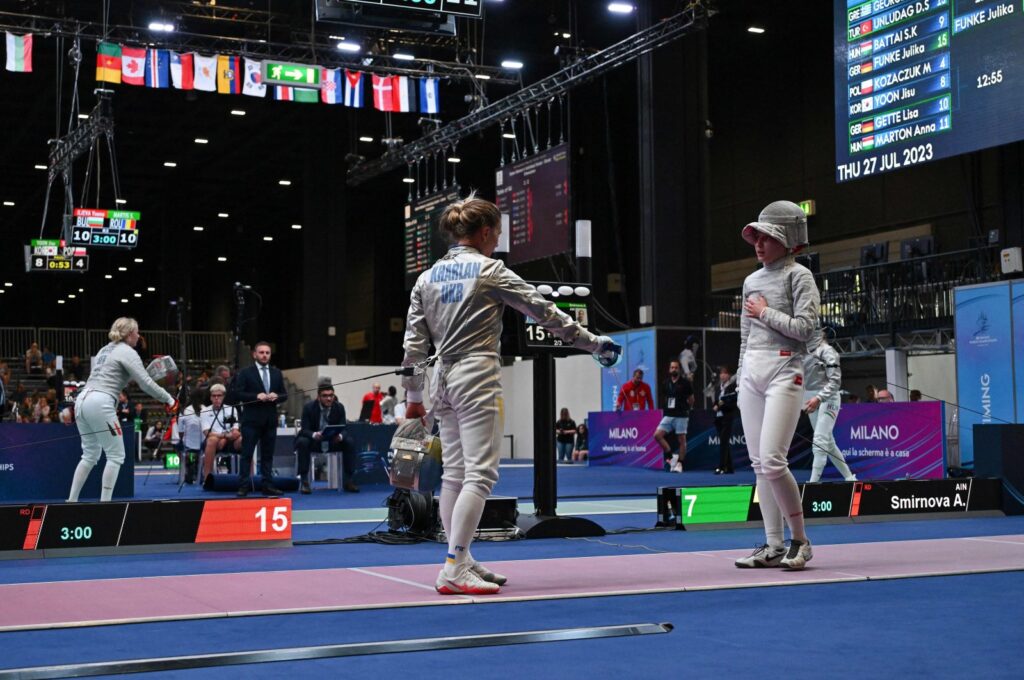Ukraine's Olha Kharlan (L) gestures as she refuses to shake hands with Russia's Anna Smirnova, registered as an Individual Neutral Athlete (AIN), after she defeated her during the Sabre Women's Senior Individual qualifiers, as part of the FIE Fencing World Championships at the Fair Allianz MI.CO, Milan, Italy, July 27, 2023. (AFP Photo)