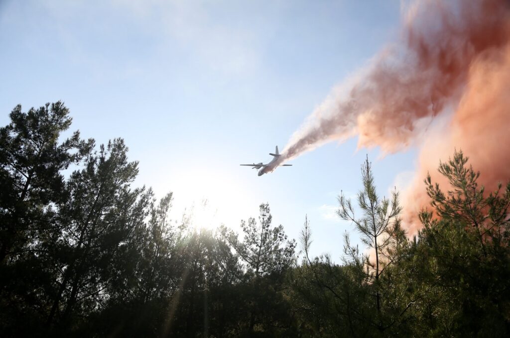 An airplane is deployed extinguishing fire over the forest in Menekşe, Muğla, western Türkiye, Aug. 1, 2023. (AA Photo)