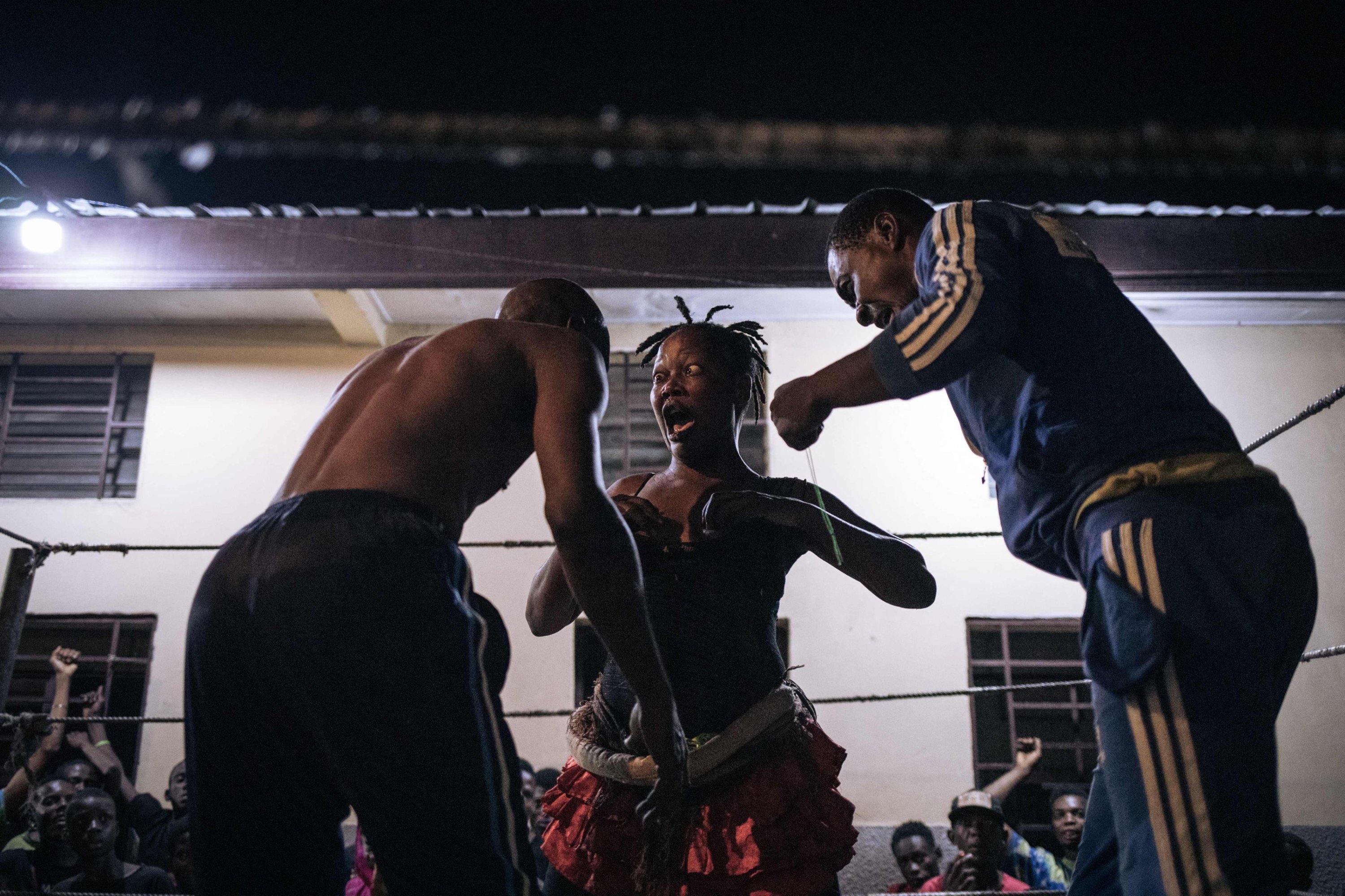 285567 Voodoo wrestler Maitresse Libondans faces off with her opponent and a referee in a schoolyard in Selemenbao district, Kinshasa, Democratic Republic of Congo, July 29, 2023. (AFP Photo)