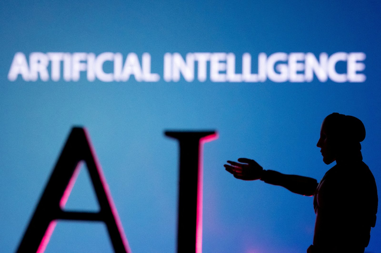 Artificial intelligence letters and robot miniature are seen in this illustration photo, June 23, 2023. (Reuters Photo)