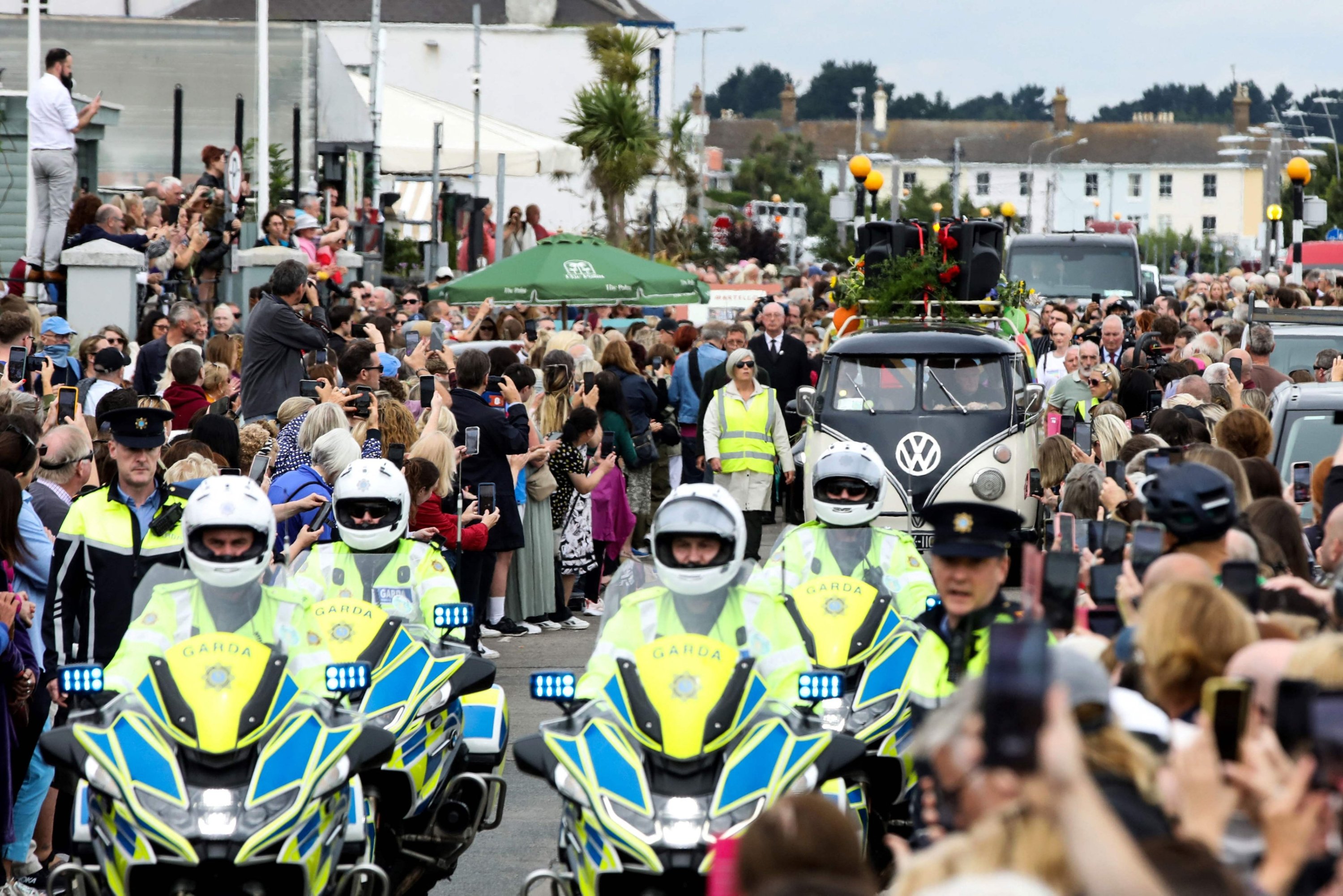 286568 People gather to pay a tribute during the funeral procession of late Irish singer Sinead O'Connor, outside the former home in Bray, eastern Ireland, ahead of her funeral on Aug. 8, 2023. (AFP Photo)