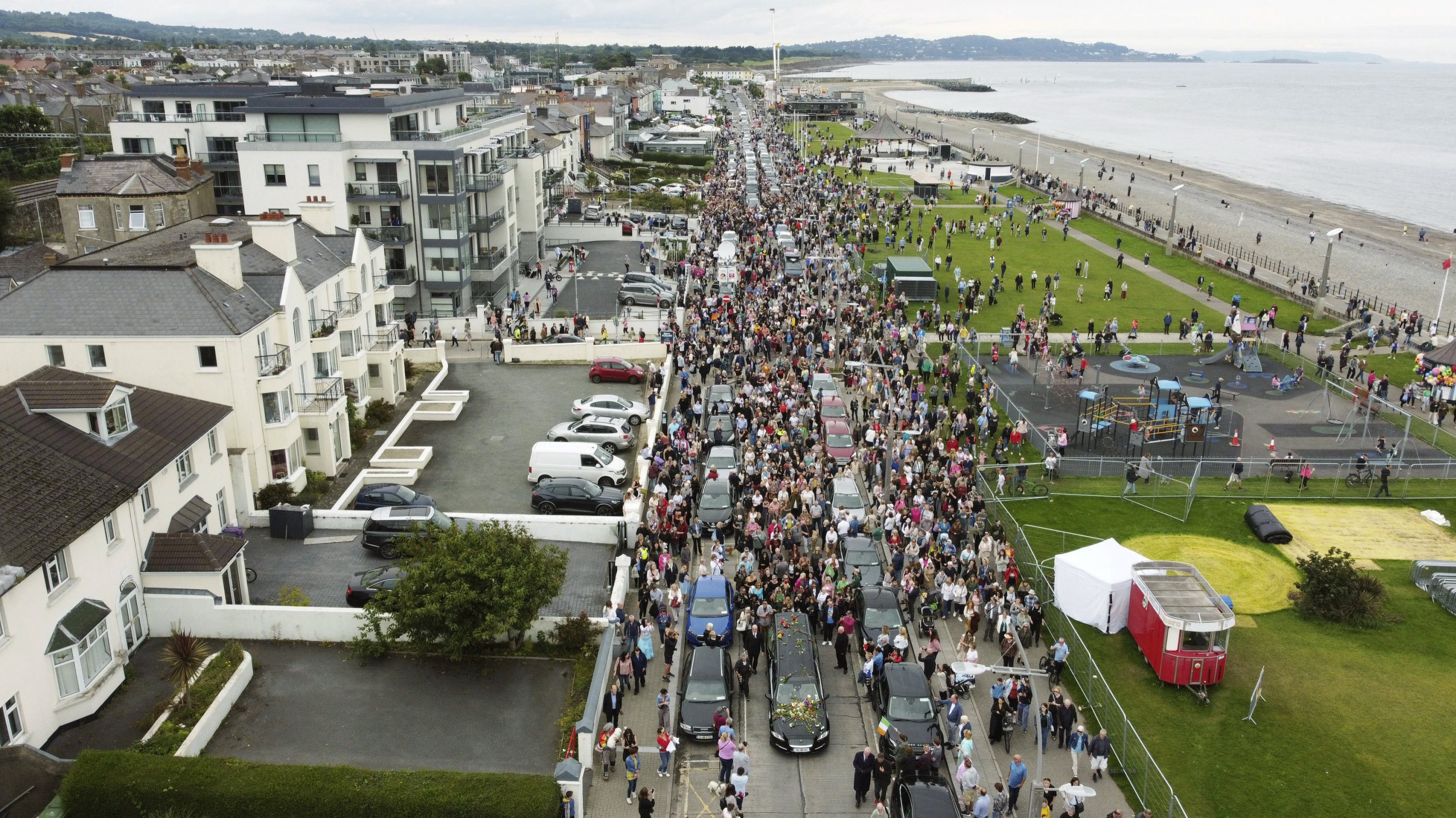 286569 Fans of singer Sinead O'Connor line the streets as her funeral cortege passes through her former hometown of Bray, Co Wicklow, Ireland, Tuesday, Aug. 8, 2023. (AP Photo)