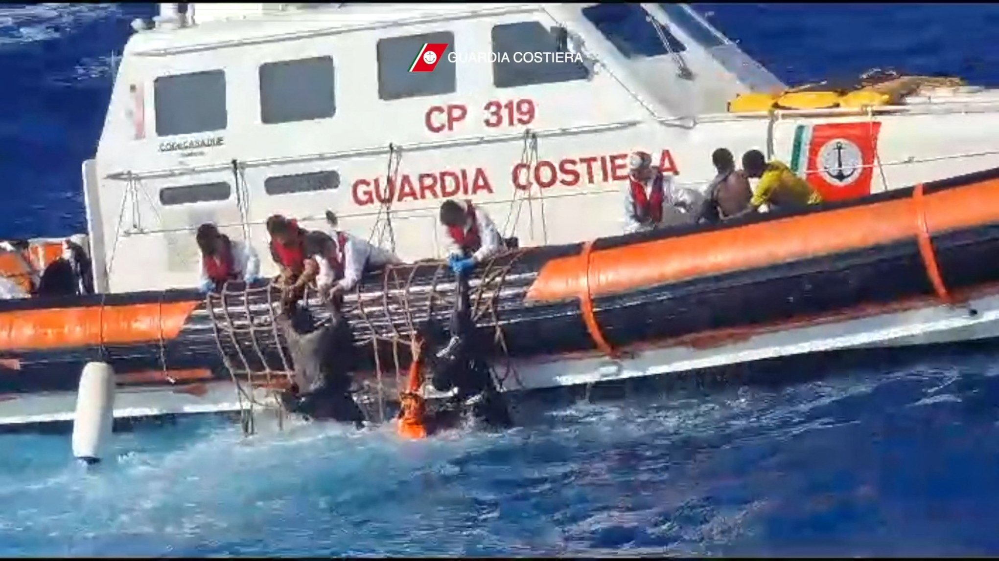 286643 Italian coast guard rescuers help migrants to board a rescue boat during operations that took place south of Lampedusa, Italy, Aug. 5, 2023. (AFP Photo)