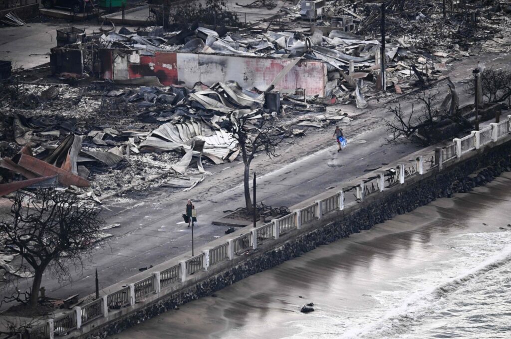 A person walking past destroyed buildings in Lahaina in the aftermath of wildfires in western Maui, Hawaii, Aug. 10, 2023. (AFP Photo)