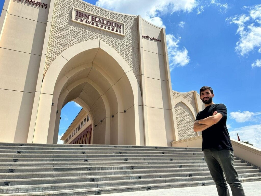 Yılmaz Acar poses in front of Ibn Haldun University, Istanbul, Türkiye, Aug. 11, 2023. (Courtesy of Ibn Haldun University)
