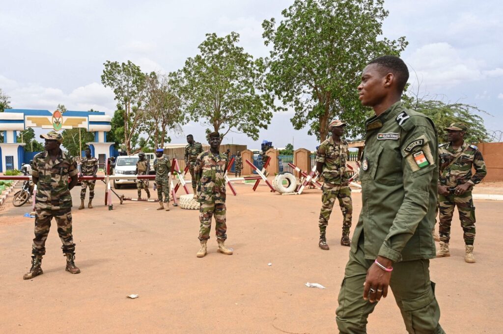 Nigerien soldiers stand guard as supporters of Niger's National Council for the Safeguard of the Homeland (CNSP) gather for a demonstration in Niamey on Aug. 11, 2023. (AFP Photo)
