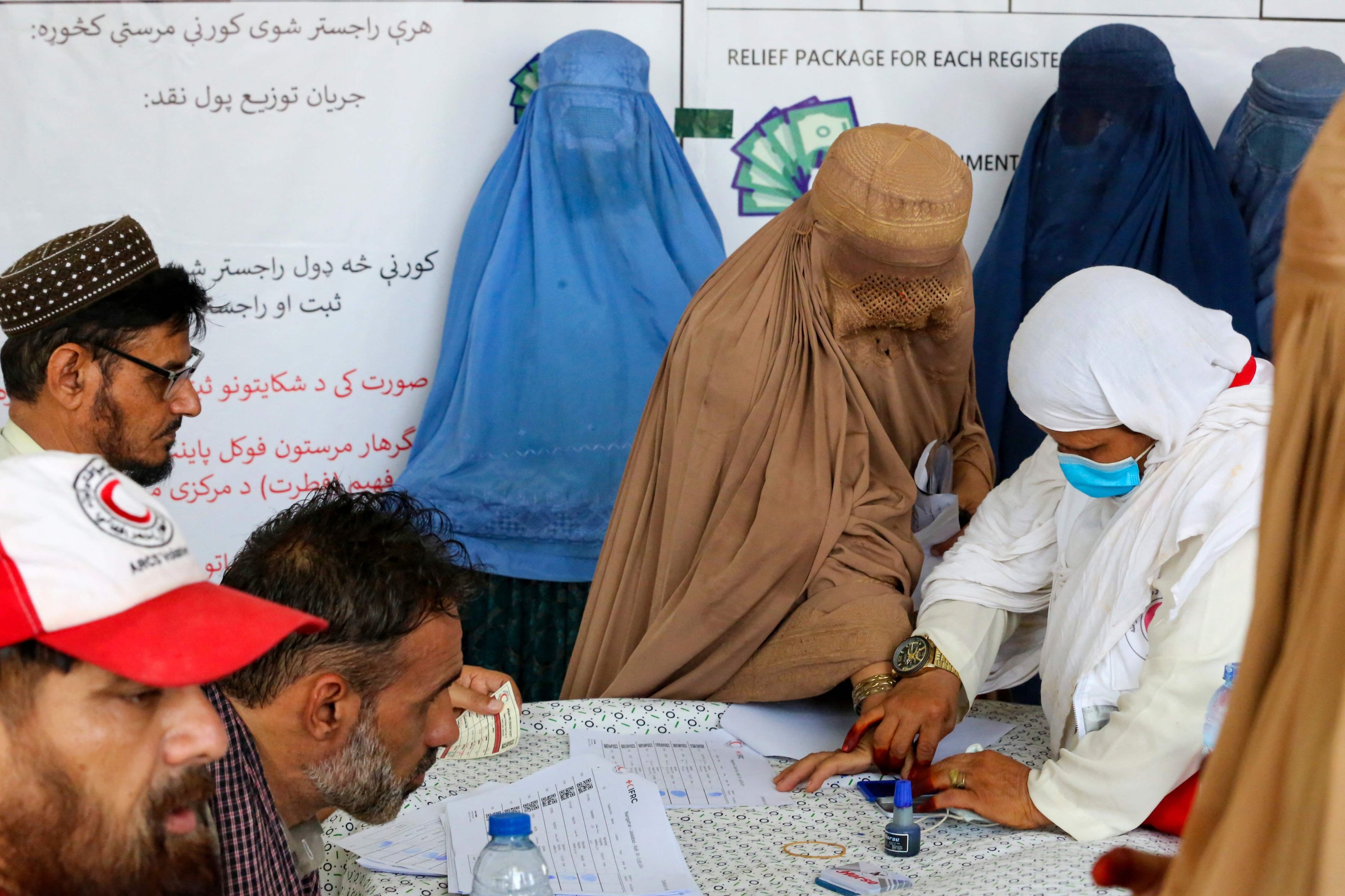 287109 Afghan burqa-clad women receive humanitarian aid from the International Federation of Red Cross and Red Crescent Societies (IFRC), Afghanistan, Aug. 6, 2023. (AFP Photo)