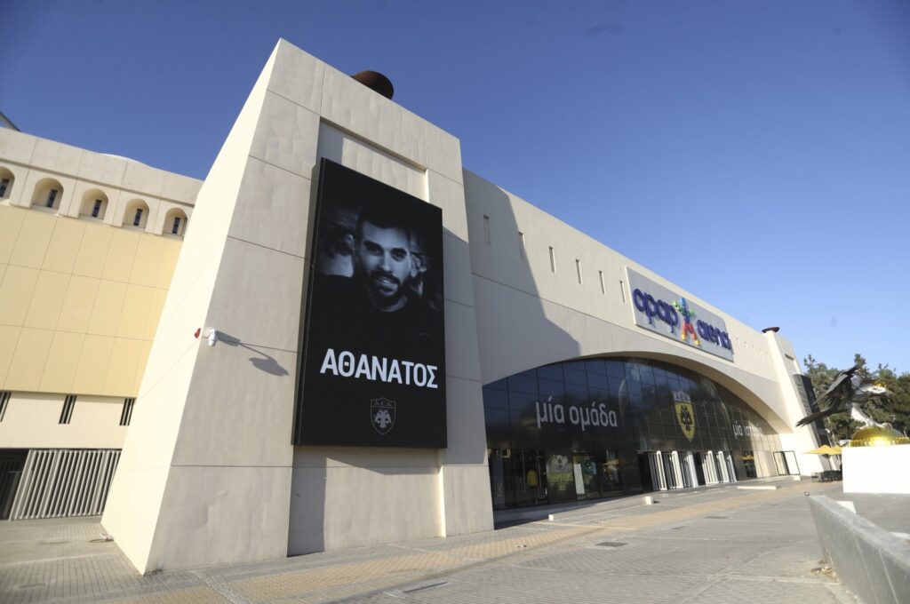A banner depicting AEK Athens fan Michalis Katsouris outside AEK's Opap Arena, Athens, Greece, Aug. 11, 2023. (AP Photo)