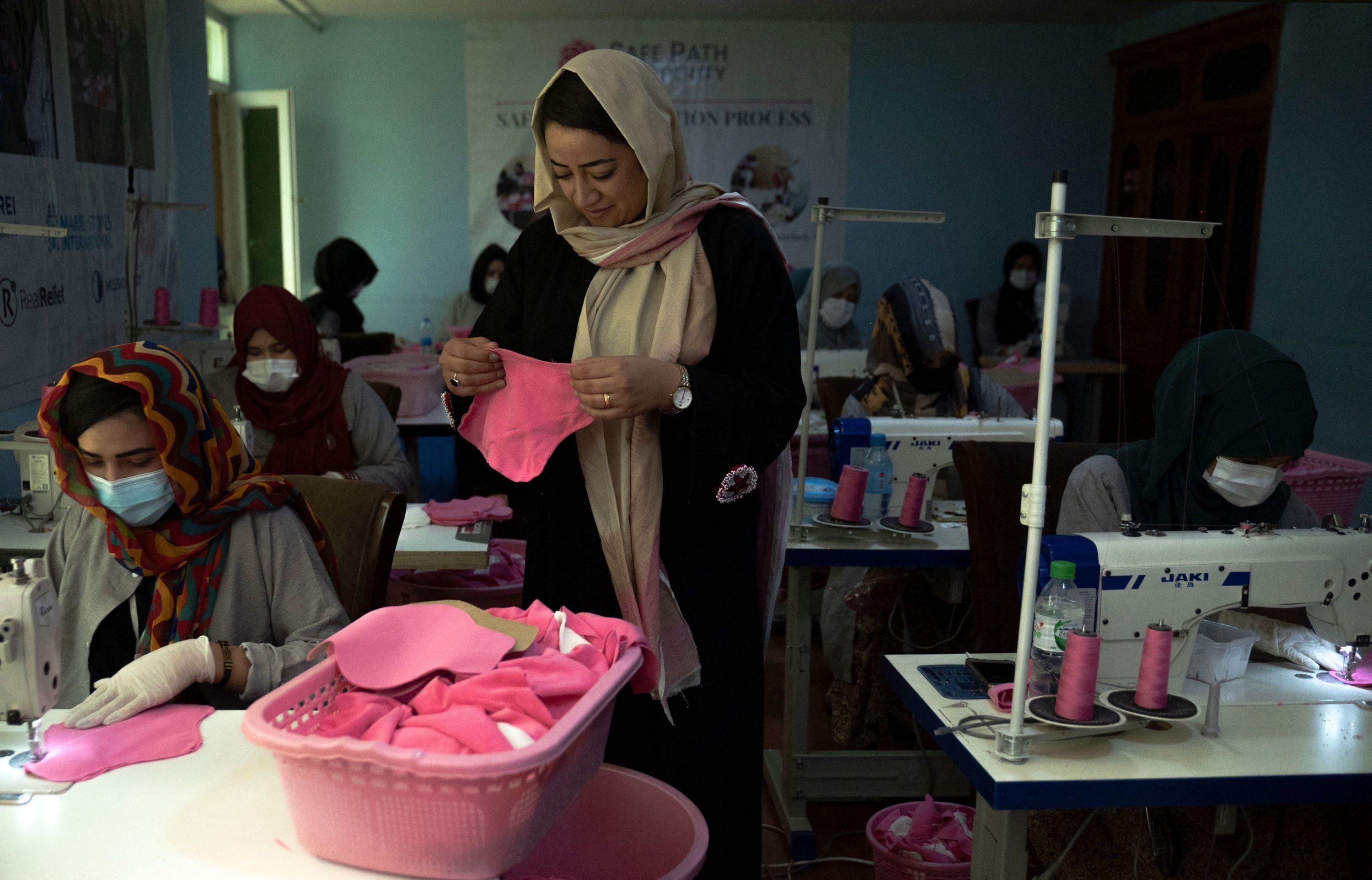 287394 Arezo Osmani (C), owner of Safe Path Prosperity Social Enterprise inspects a fabric sanitary pad in her tailor workshop in Kabul, Afghanistan, July 31, 2023. (AFP Photo)