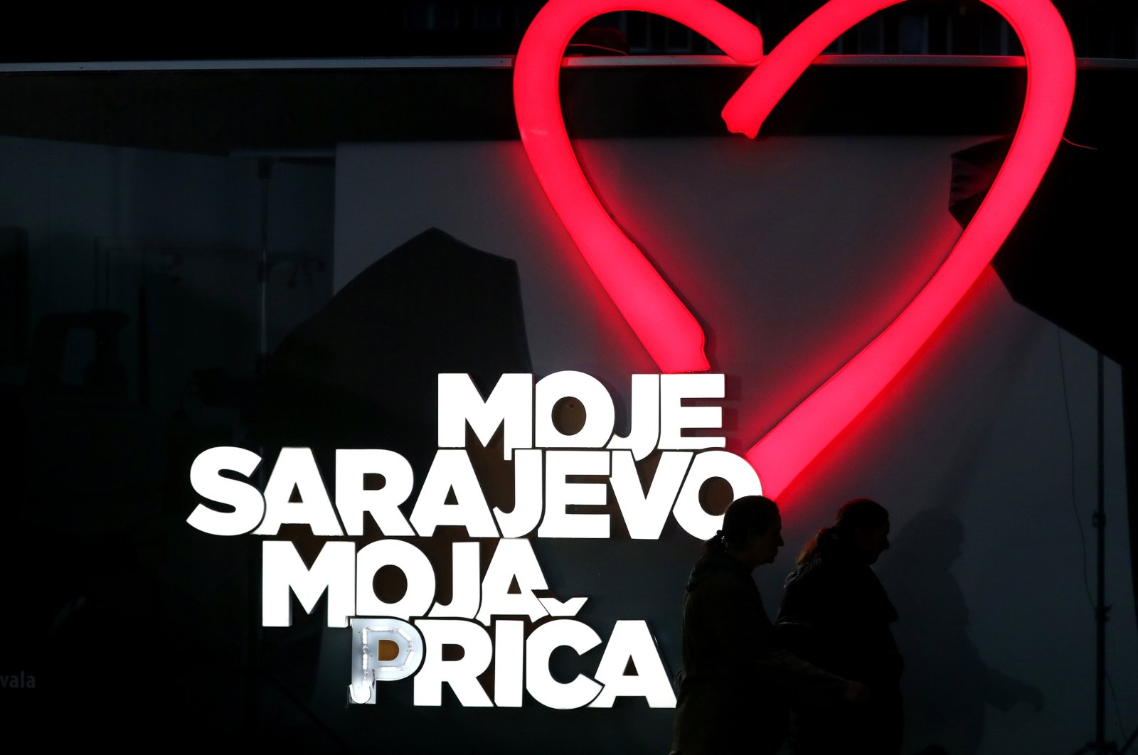 People walk in front of a poster that reads "My Sarajevo, My Story" during the closing of the 29th Sarajevo Film Festival in Sarajevo, Bosnia and Herzegovina, Aug. 18, 2023. (EPA Photo)