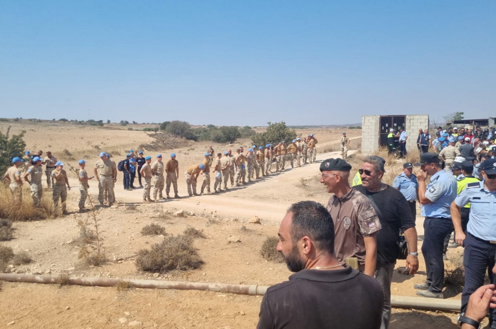Turkish Cypriot security forces and U.N. peacekeepers stand at the site in the buffer zone, the island of Cyprus, Aug. 18, 2023. (AA Photo)