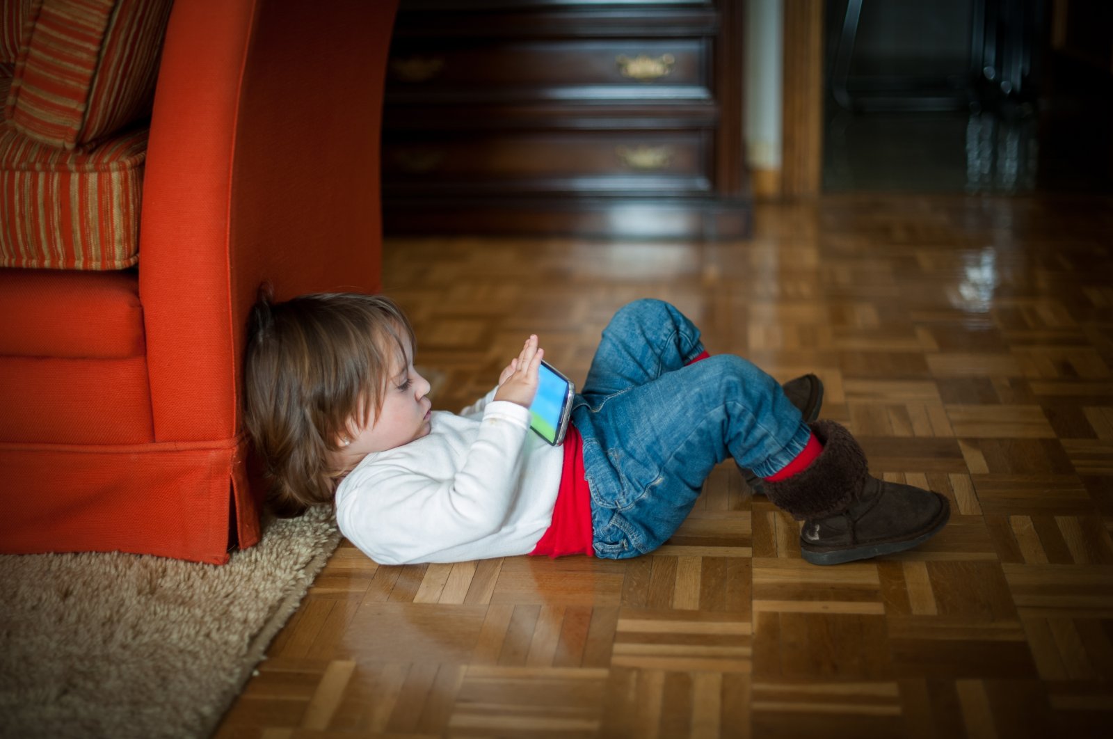 A kid is seen sitting in a passive position, surfing on the mobile phone, Aug. 20, 2023. (Getty Images)