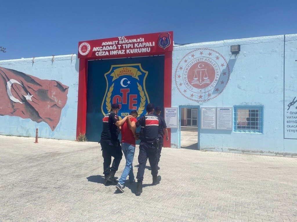 Two gendarmerie officers escort a FETÖ member wanted for dodging a prison sentence to a correctional facility in the eastern Malatya province, Türkiye, July 28, 2023. (IHA Photo)