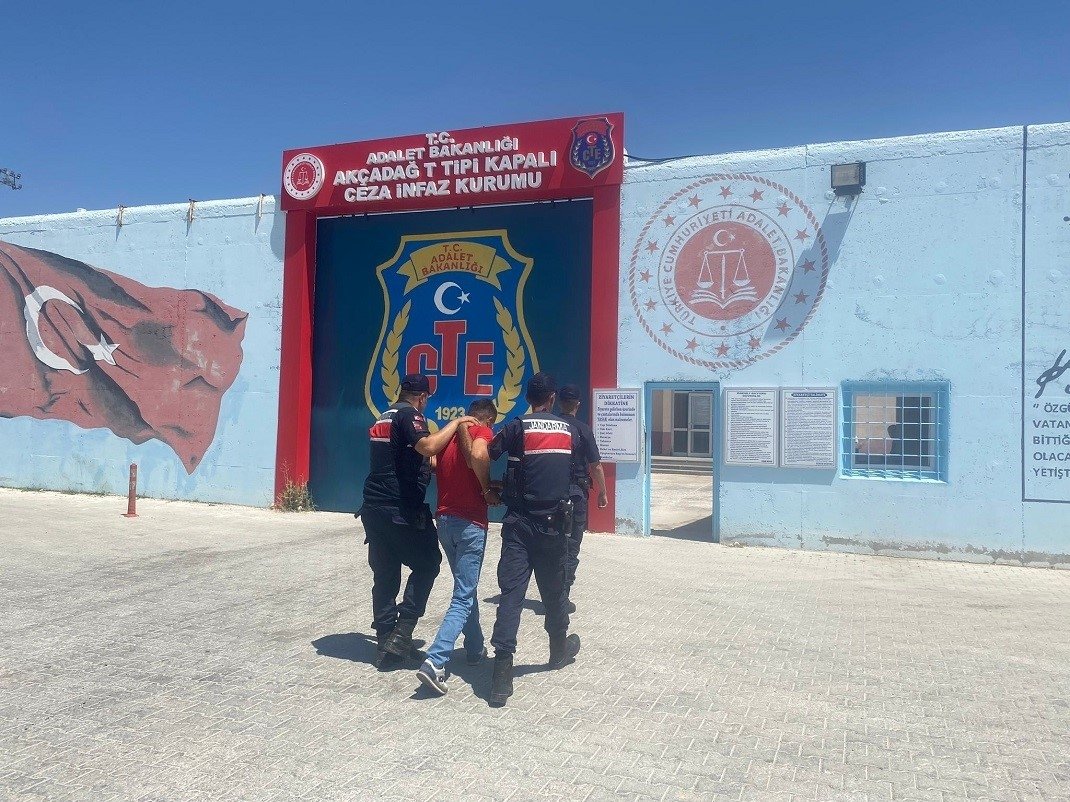 Two gendarmerie officers escort a FETÖ member wanted for dodging a prison sentence to a correctional facility in the eastern Malatya province, Türkiye, July 28, 2023. (IHA Photo)