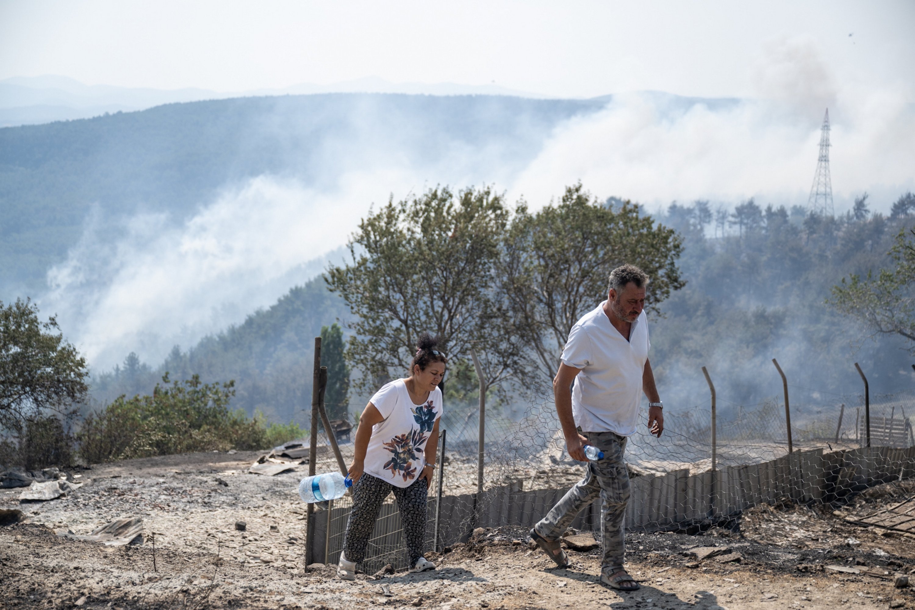 288706 Residents of the village are seen moving out amid forest fires near the Ulupınar village, Çanakkale, Türkiye, Aug. 23, 2023. (AA Photo)