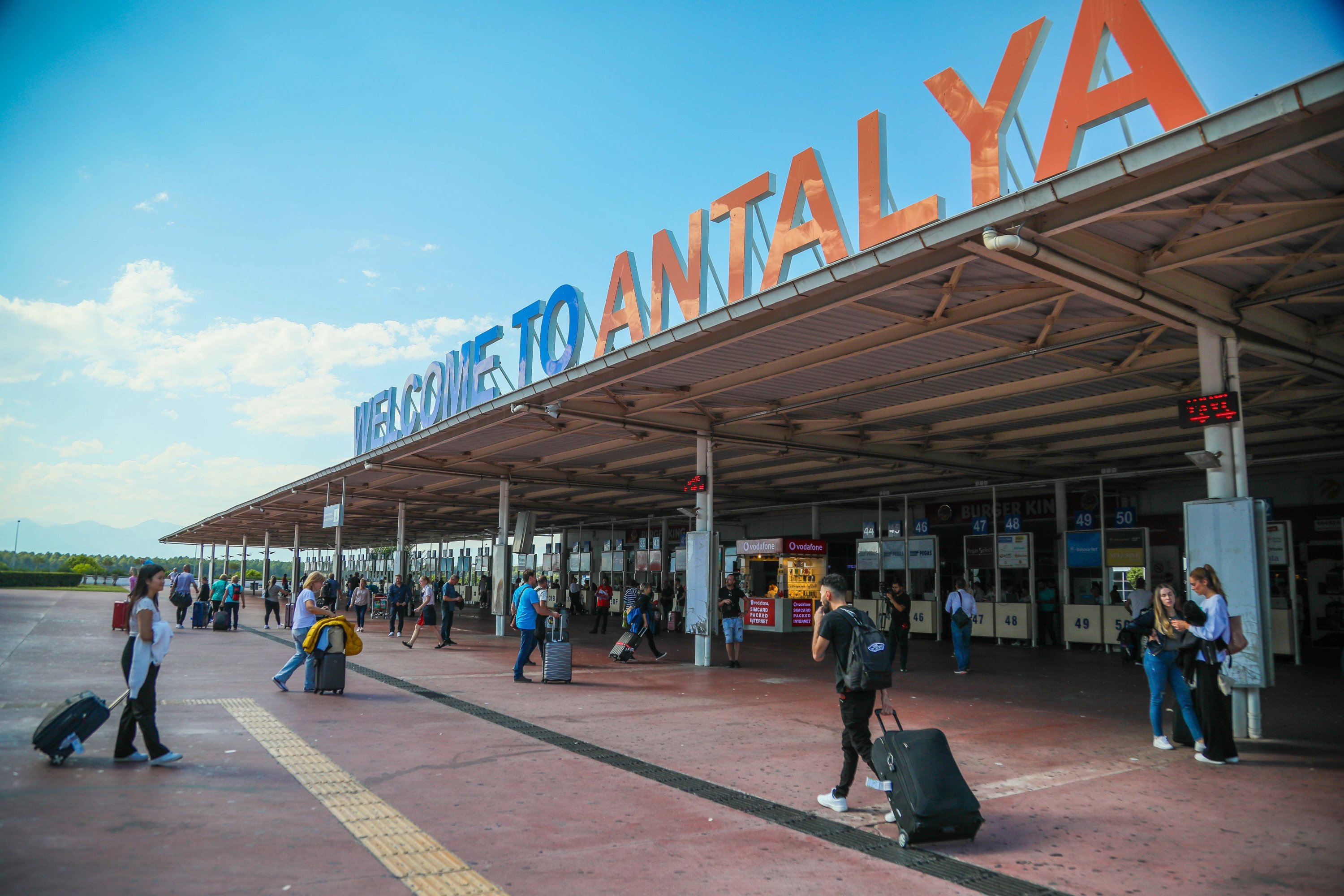 289041 Tourists are seen in front of the airport in the southern province of Antalya, Türkiye, Aug. 11, 2023. (DHA Photo)