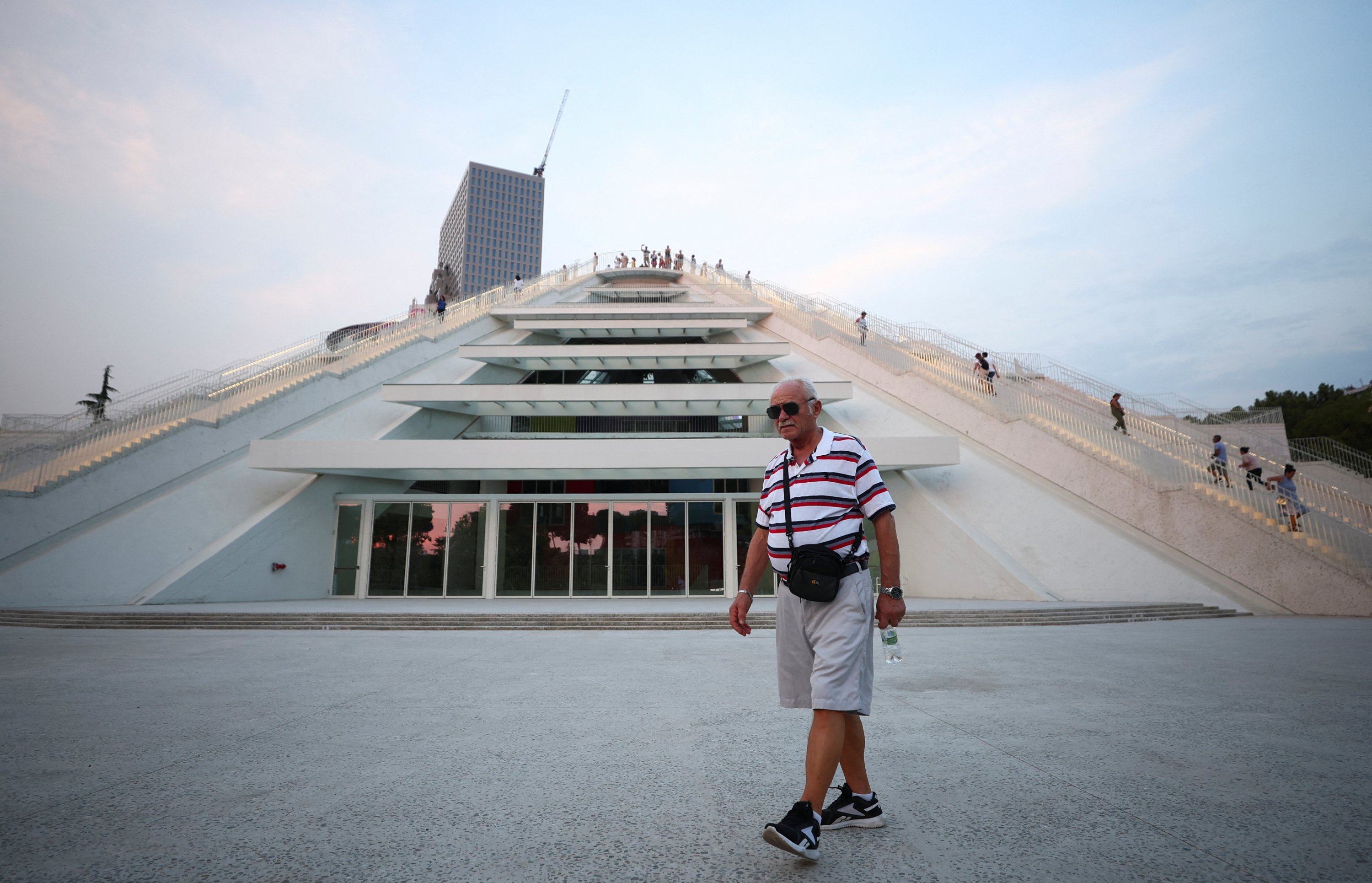 289207 A man walks in front of the redesigned pyramid that was formerly a museum for the late Communist dictator Enver Hoxha, Tirana, Albania, Aug. 24, 2023. (Reuters Photo)