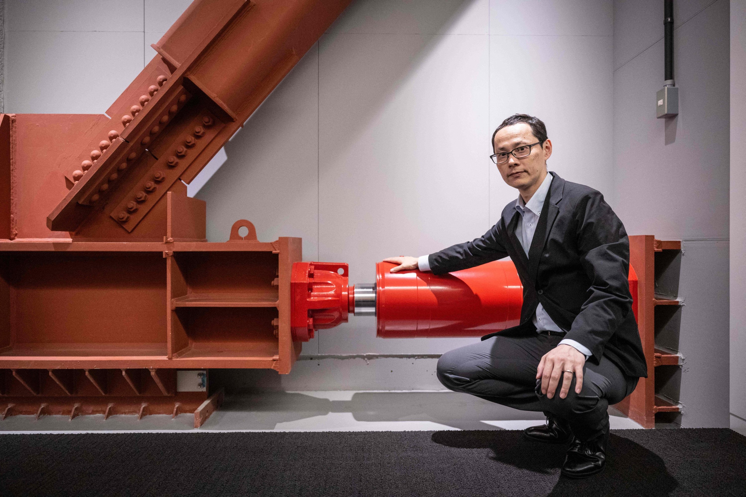 289707 Kai Toyama, a structural engineering official at real estate giant Mori Building, poses for photographs with an oil damper at Toranomon Hills Business Tower in Tokyo, Japan, June 12, 2023. (AFP Photo)