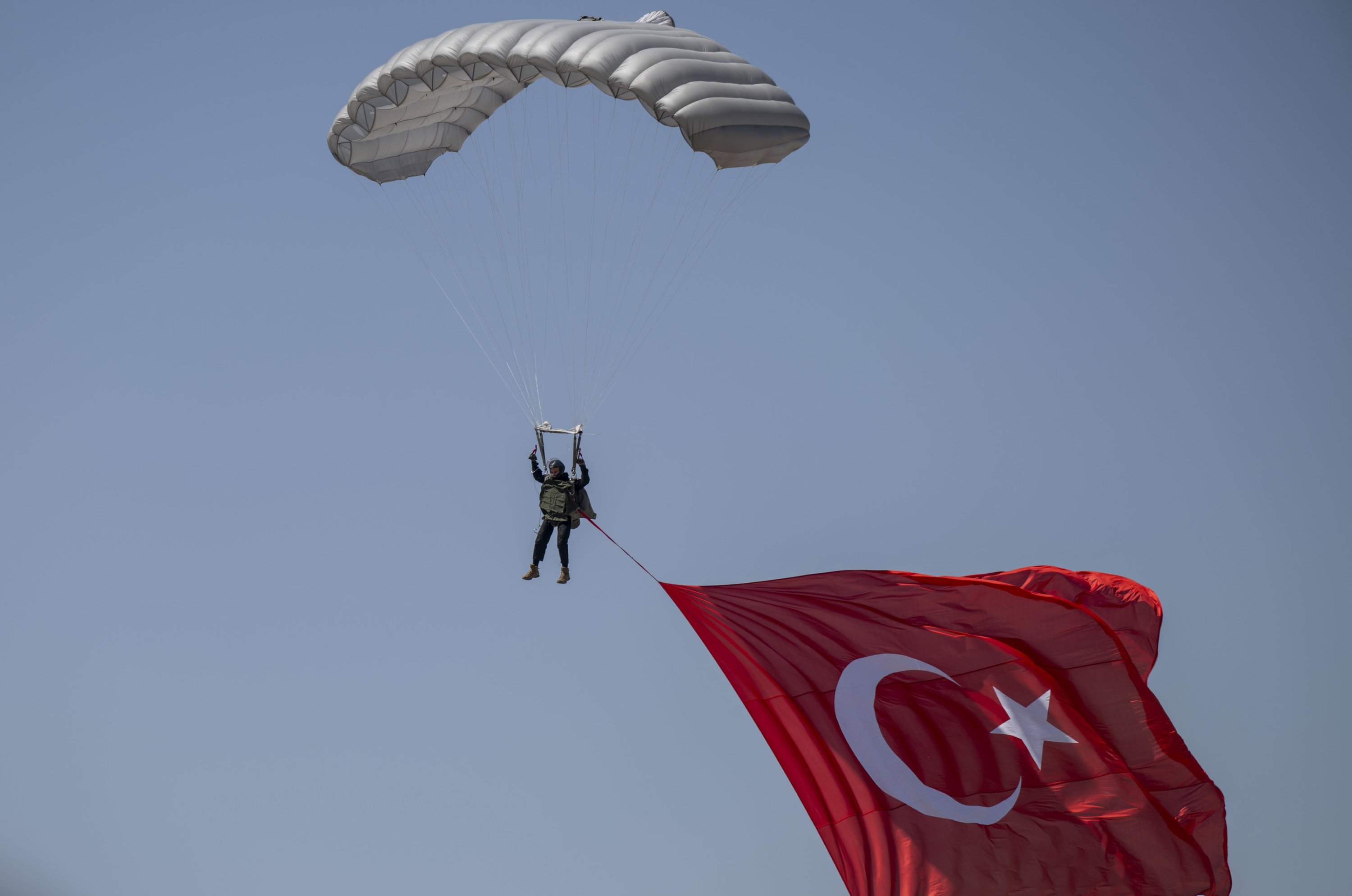 289787-1 The man on parachute is seen raising large Turkish flag as part of Teknofest, Türkiye's premier aerospace and technology festival, Ankara, Türkiye, Aug. 30, 2023. (AA Photo)