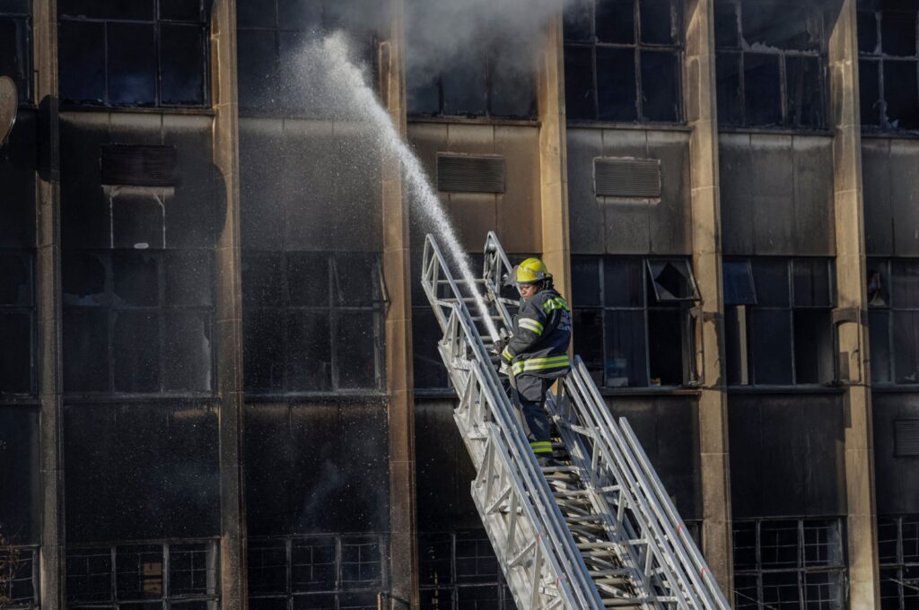 A firefighter extinguishes the fire at a building in Johannesburg, South Africa, Aug. 31, 2023. (AFP Photo)