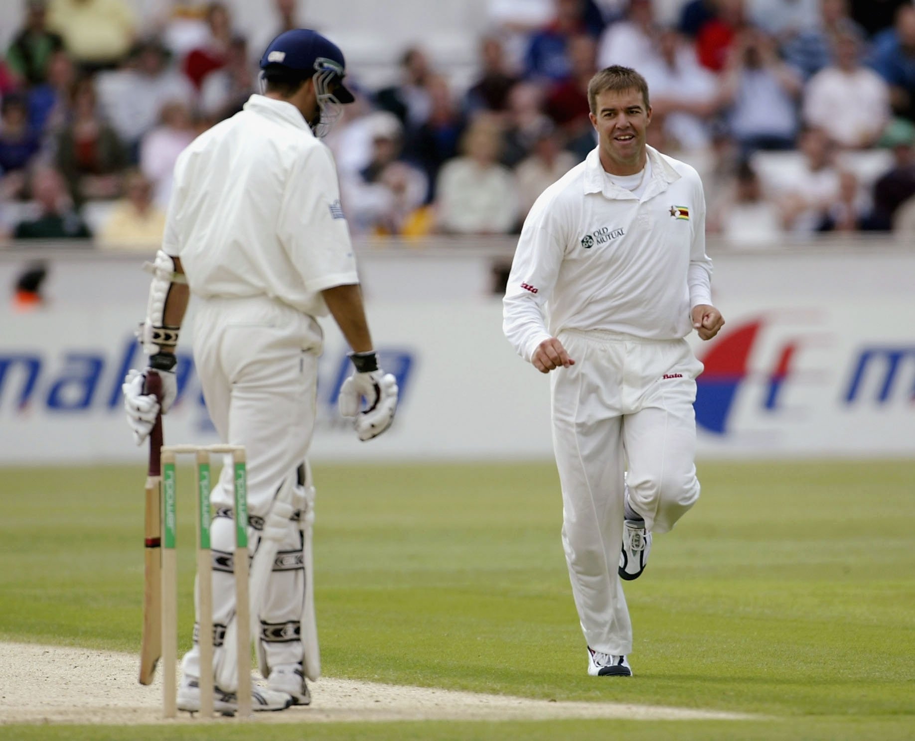 290309 Zimbabwe's Heath Streak (R) celebrates taking the wicket of Michael Vaughan of England during the first day of the second power Test match between England and Zimbabwe at The Riverside Cricket Ground, Durham, UK., June 5, 2003. (Getty Images Photo)