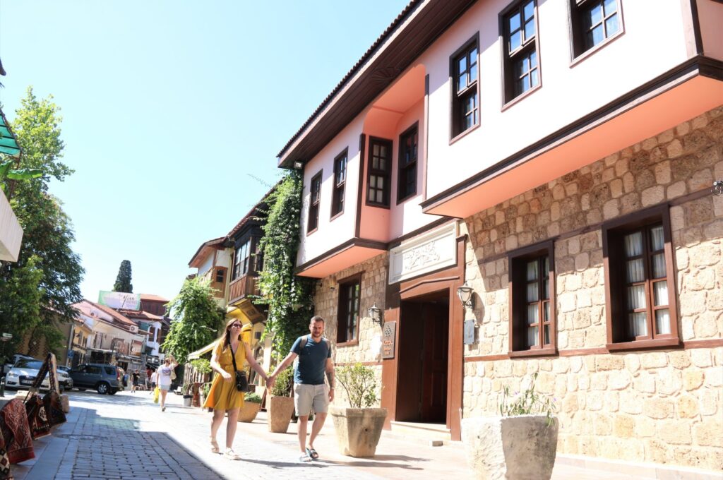 Tourists next to the old-fashioned stone houses in the historic Kaleiçi district, Antalya, southern Türkiye, Sept. 13, 2023. (IHA Photo)