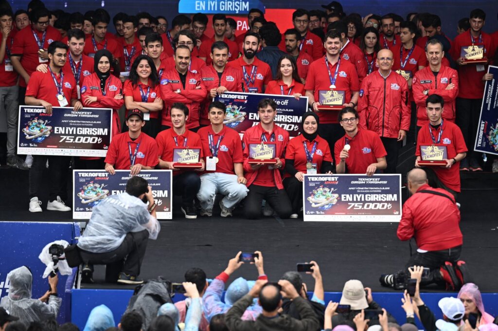 Selçuk Bayraktar, the chairperson of the T3 board of trustees (C), Industry and Technology Mehmet Fatih Kacır (4th L) along with contestants at Teknofest in capital Ankara, Türkiye, Sept. 3, 2023. (AA Photo)