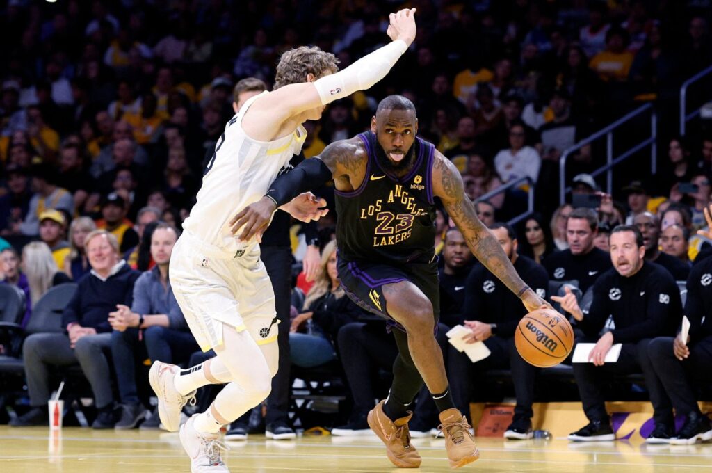 Los Angeles Lakers' LeBron James (R) drives to the basket against Utah Jazz's Lauri Markkanen during the first half of an NBA In-Season Tournament game at Crypto.com Arena, Los Angeles, California, U.S., Nov. 21, 2023. (AFP Photo)