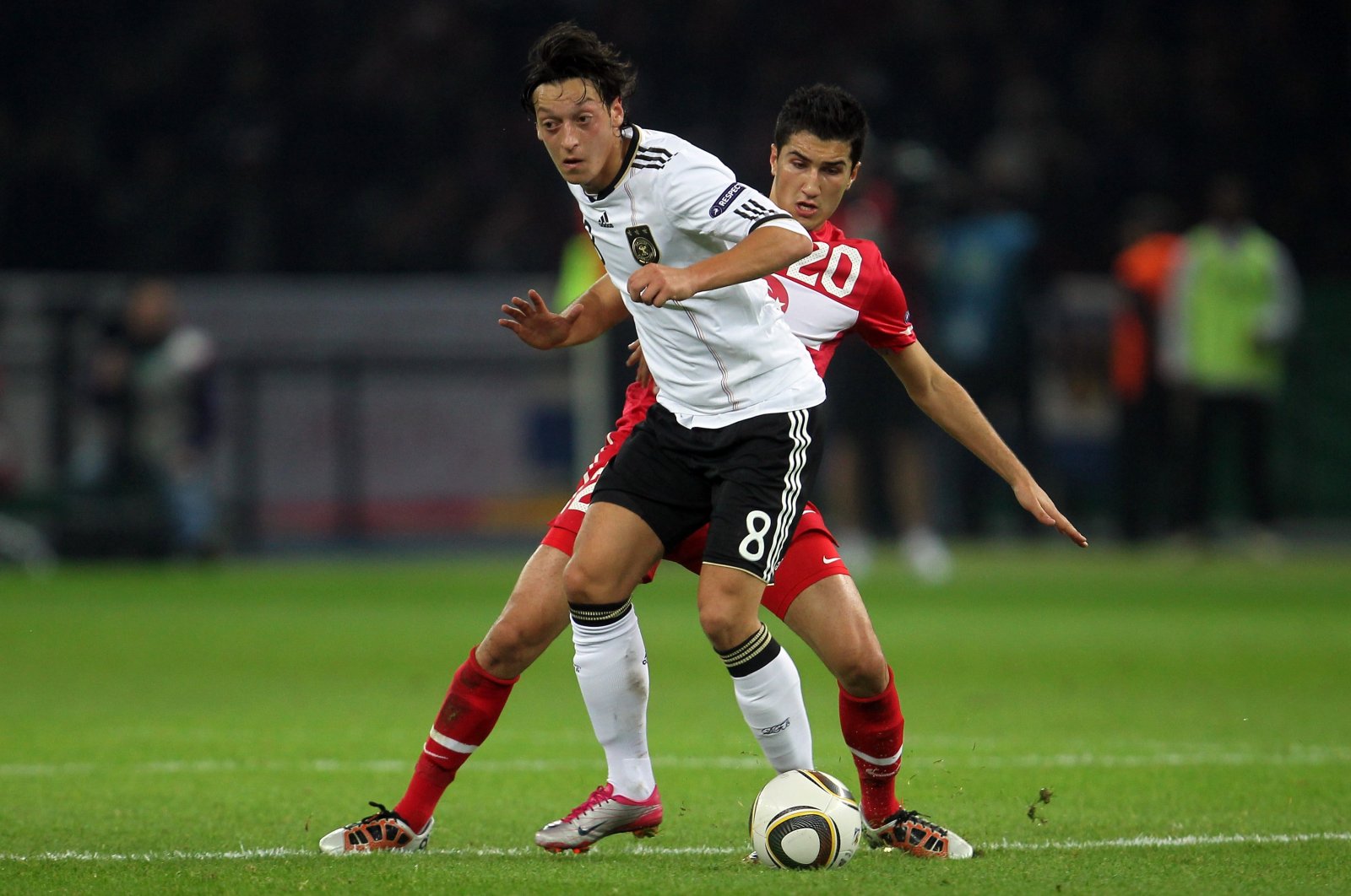 Germany's Mesut Özil (L) is challenged by Türkiye's Nuri Sahin during the Euro 2012 Group A qualifier match at Olympic Stadium, Berlin, Germany, Oct. 8, 2010.  (Getty Images Photo)