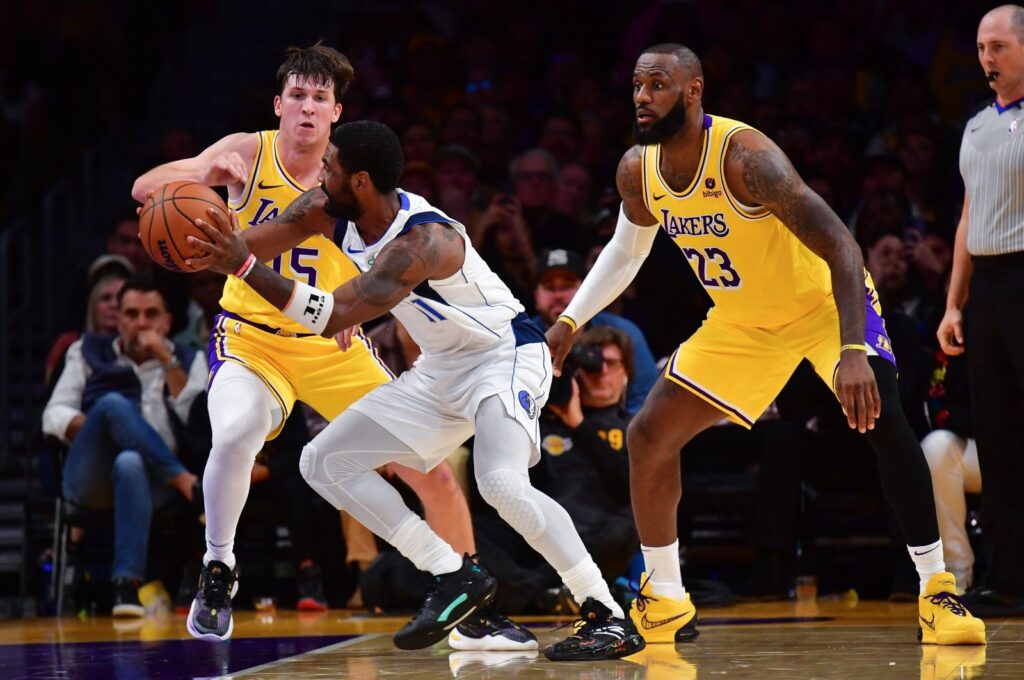 Dallas Mavericks' Kyrie Irving (C) moves the ball against Los Angeles Lakers' Austin Reaves (L) and LeBron James (23) during the second half at Crypto.com Arena, Los Angeles, California, U.S., Nov 22, 2023. (Reuters Photo)