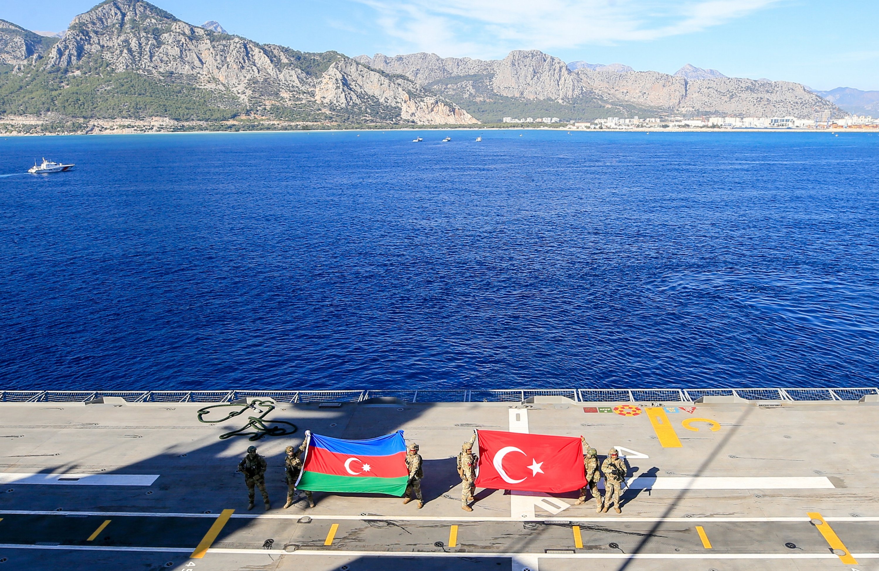 302494 Turkish naval forces unfurl Turkish and Azerbaijani flags as a show of fraternity after the Eastern Mediterranean-2023 Exercise onboard the TCG Anadolu, in southern Antalya province, Türkiye, Nov. 23, 2023. (AA Photo)