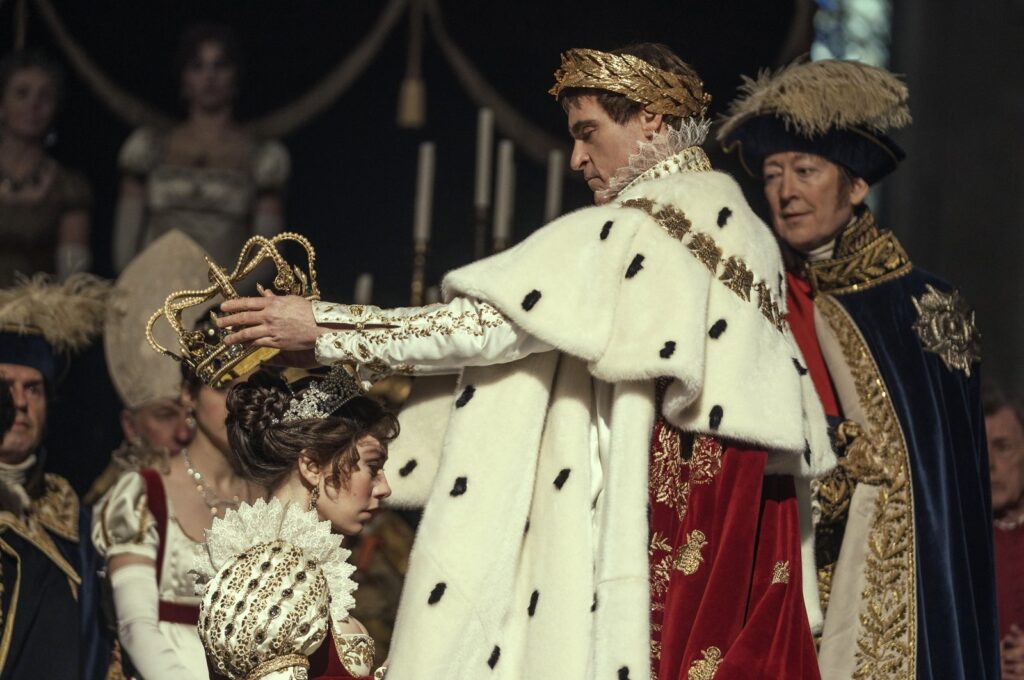 This image released by Apple TV  shows Vanessa Kirby, (foreground L) and Joaquin Phoenix in a scene from "Napoleon." (AP Photo)