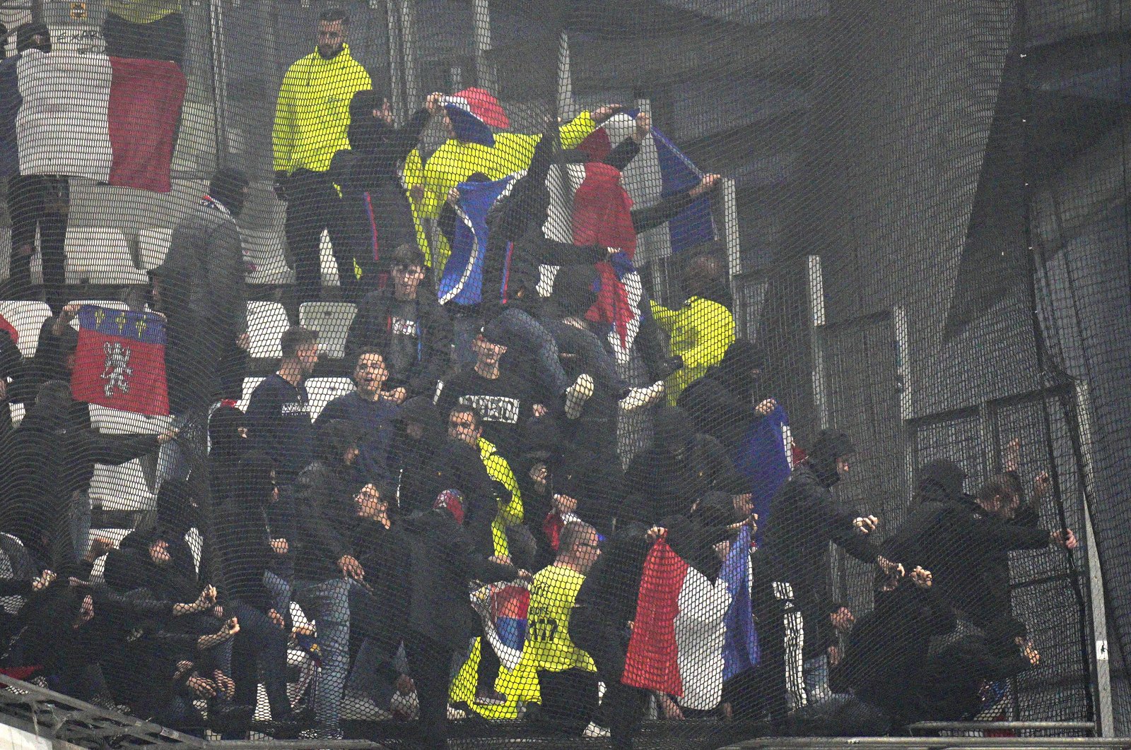 Lyon fans try to break the net on the stands prior to the French Ligue 1 match against Marseille, Velodrome Stadium, Marseille, France, Oct. 29, 2023. (AP Photo)