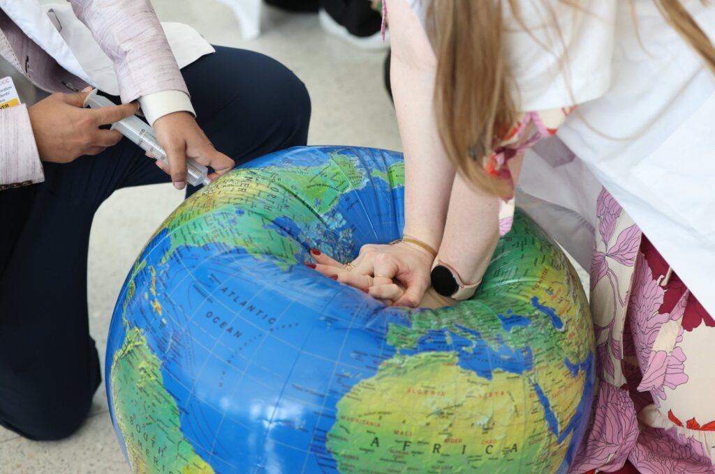 Activists perform CPR on an inflated globe model during a protest "End Fossil Fuel now! Climate Crisis = Health Crisis" during the U.N. Climate Change Conference (COP28), Dubai, UAE, Dec. 6, 2023. (EPA Photo)