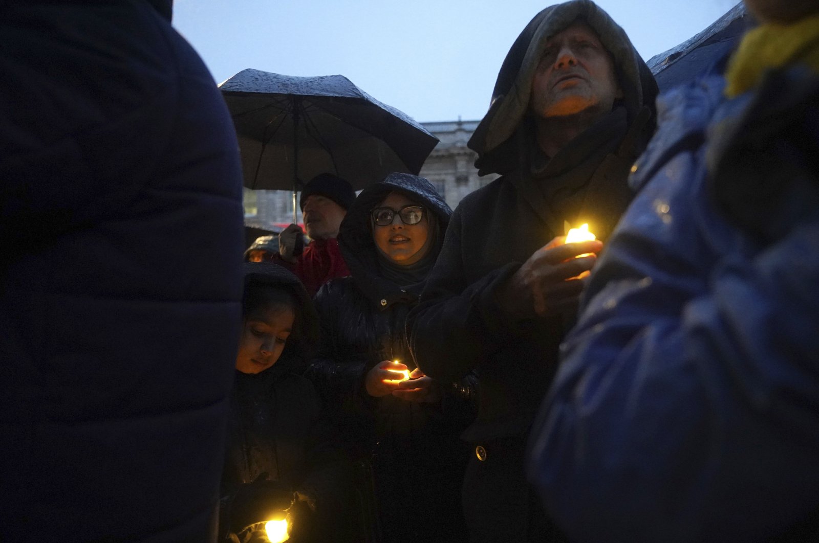 People hold candles during a anti-hate vigil on Whitehall, London, Dec. 3, 2023. (AP Photo)